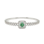 Silver bracelet with a green gemstone on a white background