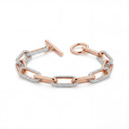 Rose gold chain bracelet with diamond accents on a white background