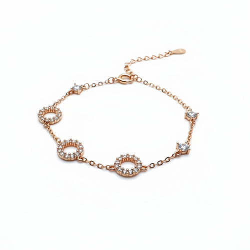 Rose gold bracelet with diamond accents on a white background