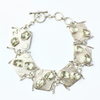 Silver bracelet with green gemstones on a white background