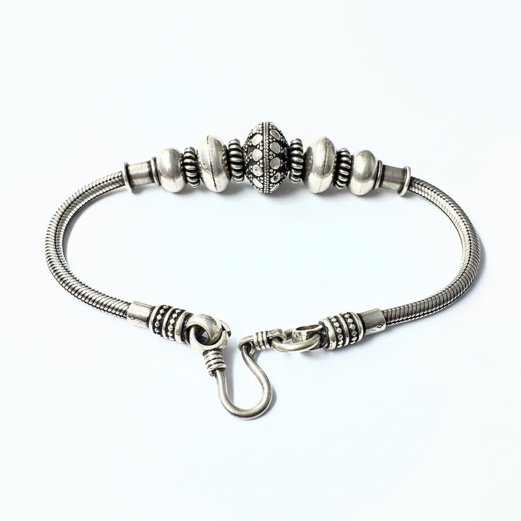 Silver bracelet with beads on a white background