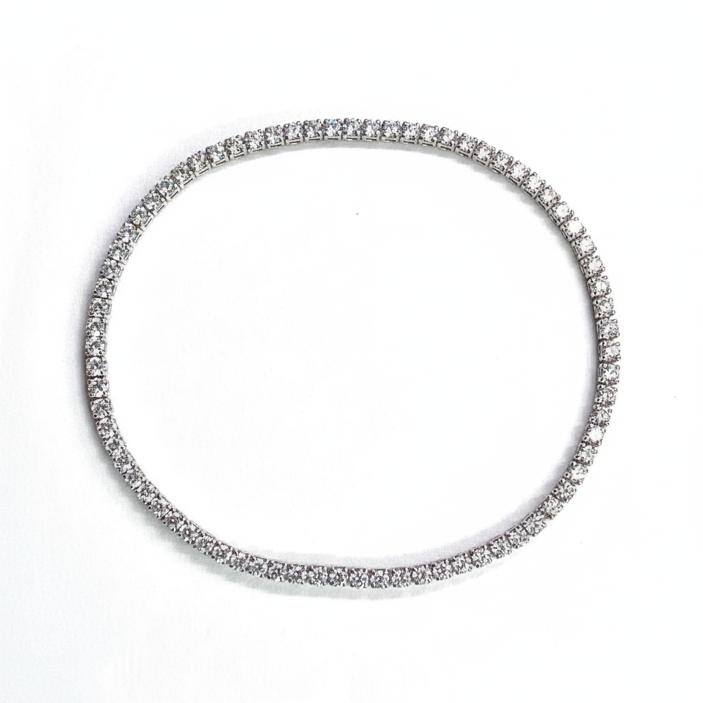 Silver bracelet with clear stones on a white background