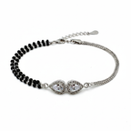 Bracelet with black beads and silver clasp on a white background