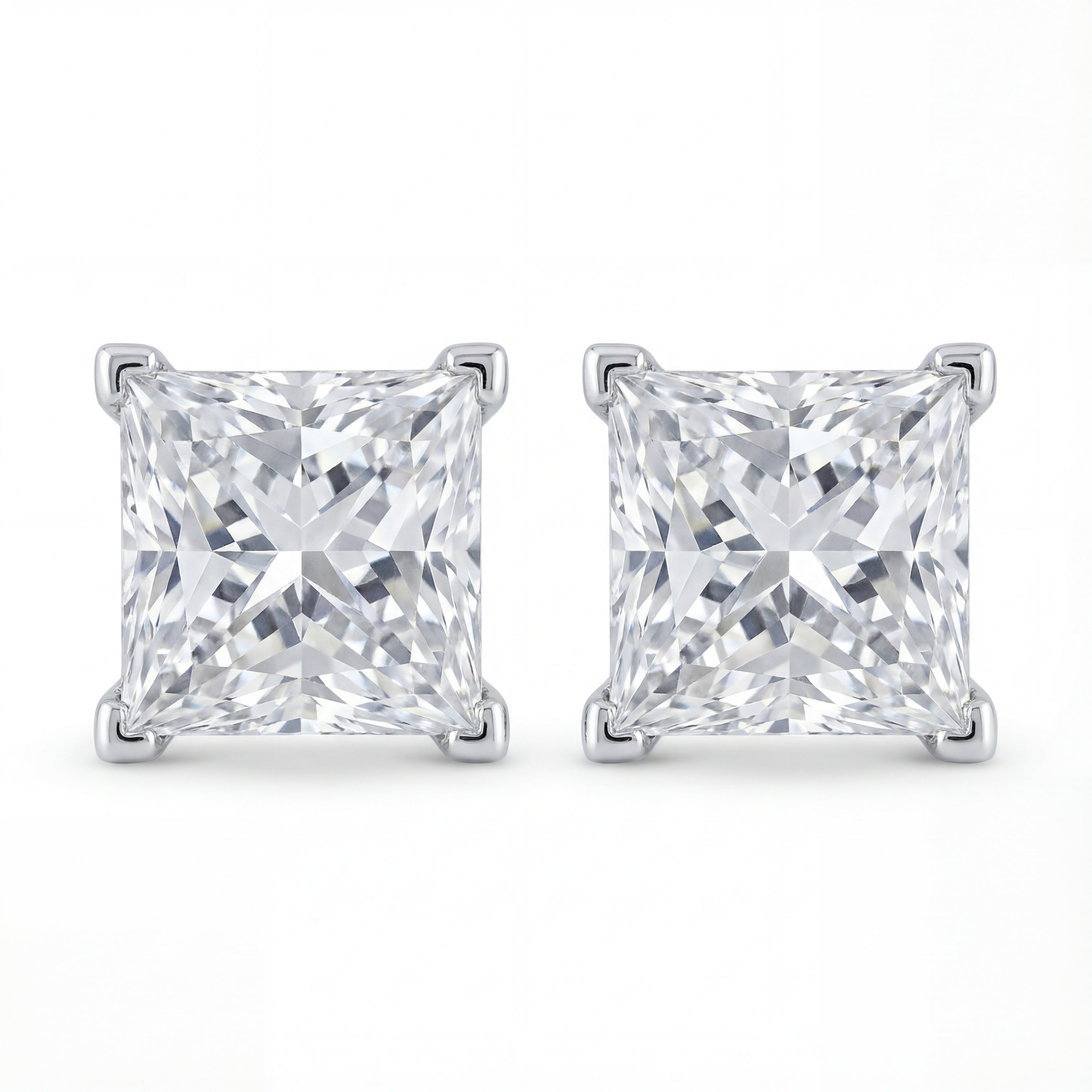 Pair of square-cut diamond stud earrings on a white background