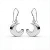 Silver crescent moon earrings on a white background