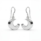 Silver crescent moon earrings on a white background