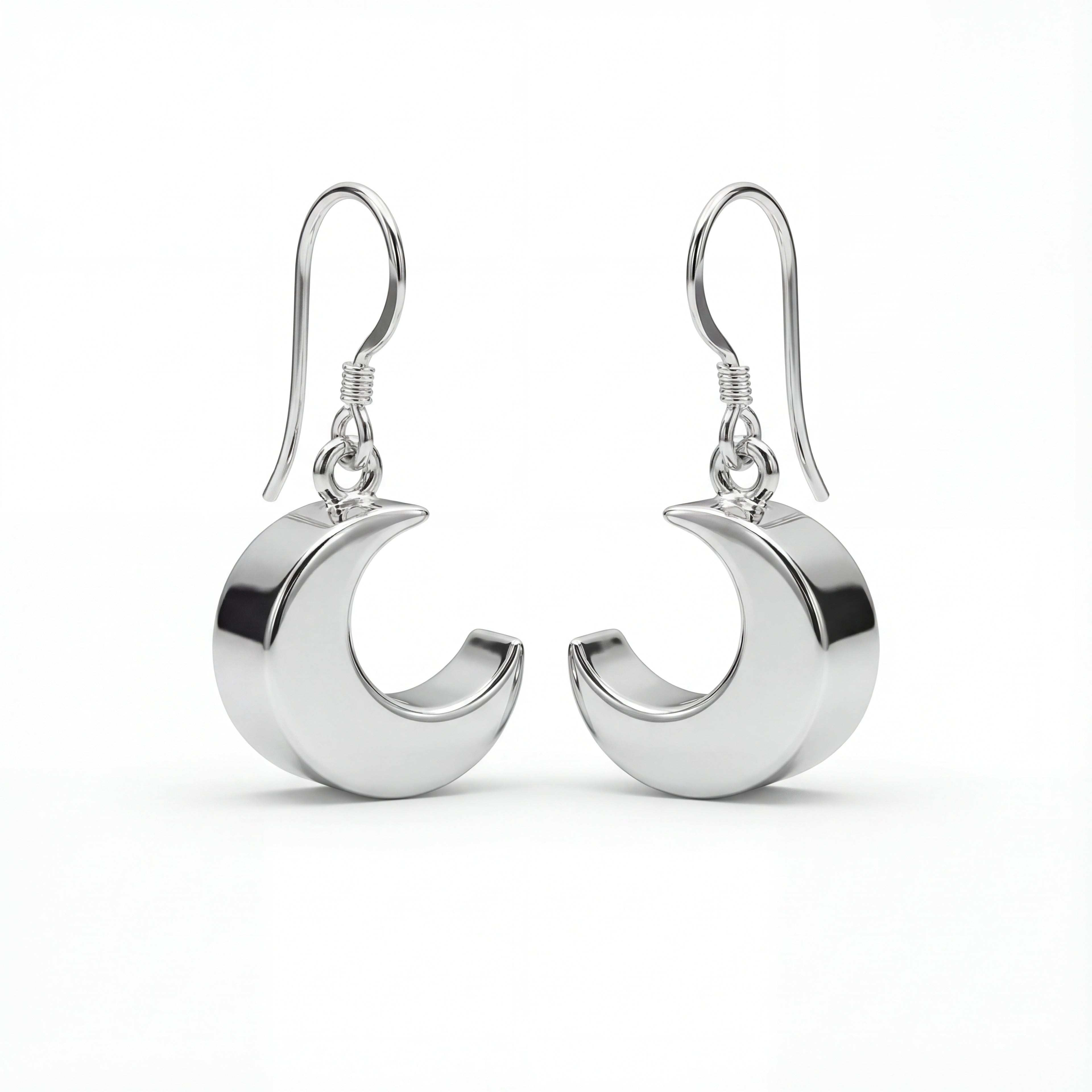Silver crescent moon earrings on a white background