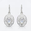 Silver earrings with moonstone stones on a white background