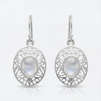 Silver earrings with moonstone stones on a white background