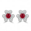 Pair of earrings with red gemstones and silver butterfly designs on a white background