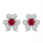 Pair of earrings with red gemstones and silver butterfly designs on a white background