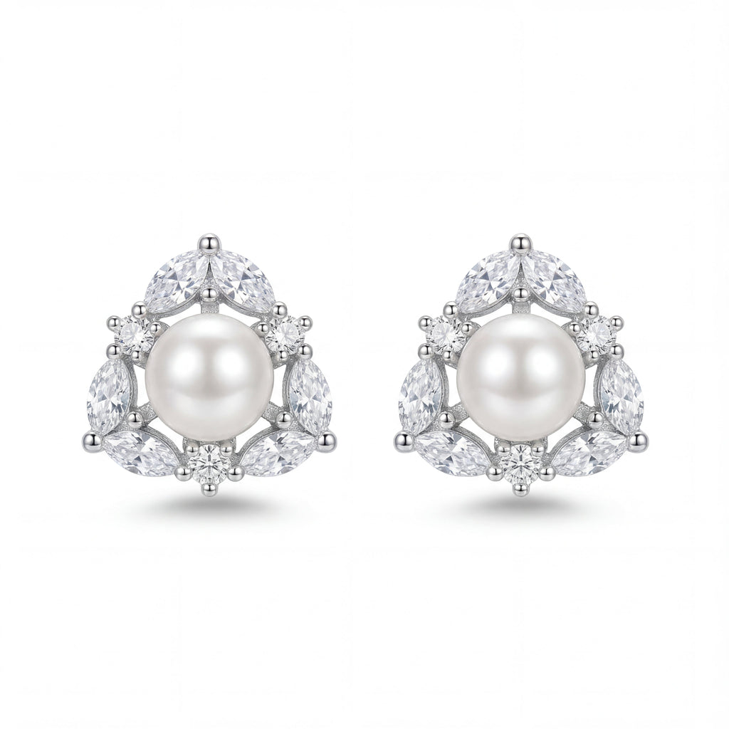 Pair of pearl earrings with diamond accents on a white background