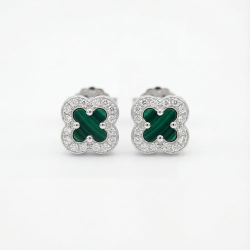 Pair of clover-shaped earrings with green centers and silver borders on a white background