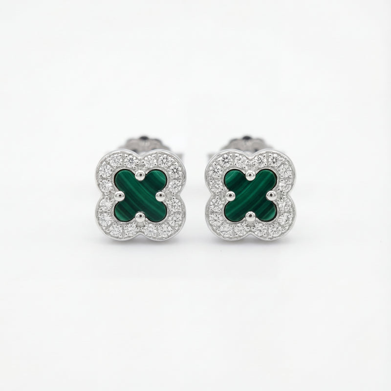 Pair of clover-shaped earrings with green centers and silver borders on a white background