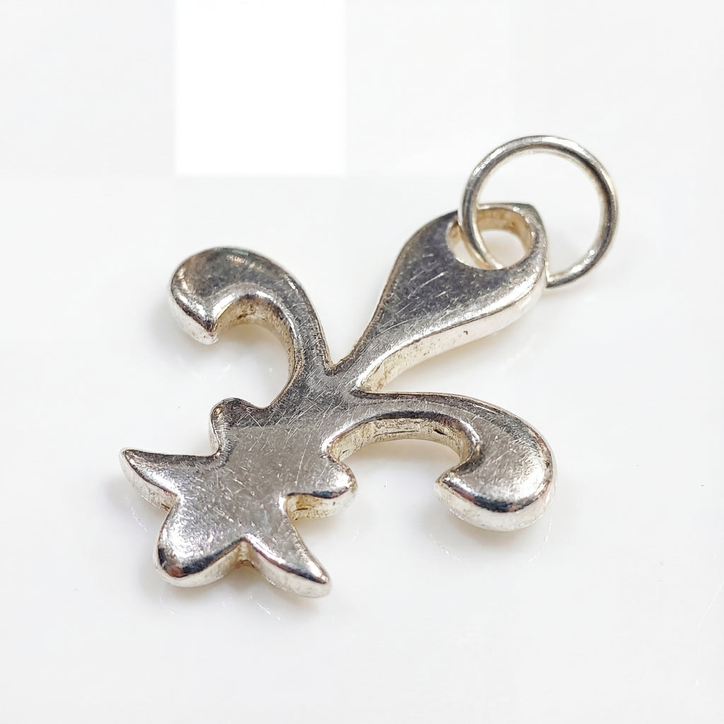 Silver fleur-de-lis pendant on a white background
