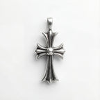 Silver cross pendant on a white background