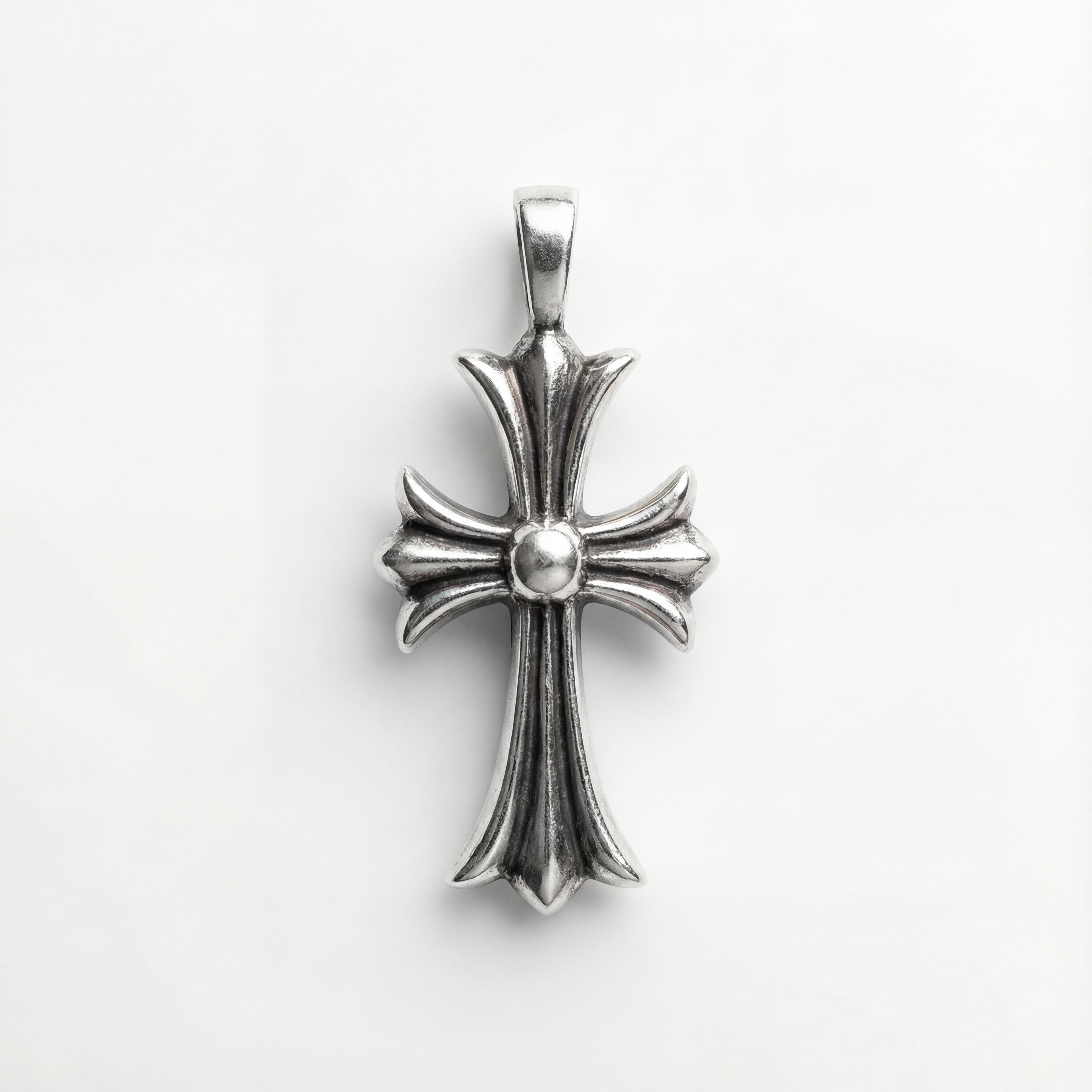 Silver cross pendant on a white background