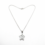 Silver star-shaped pendant on a chain against a white background