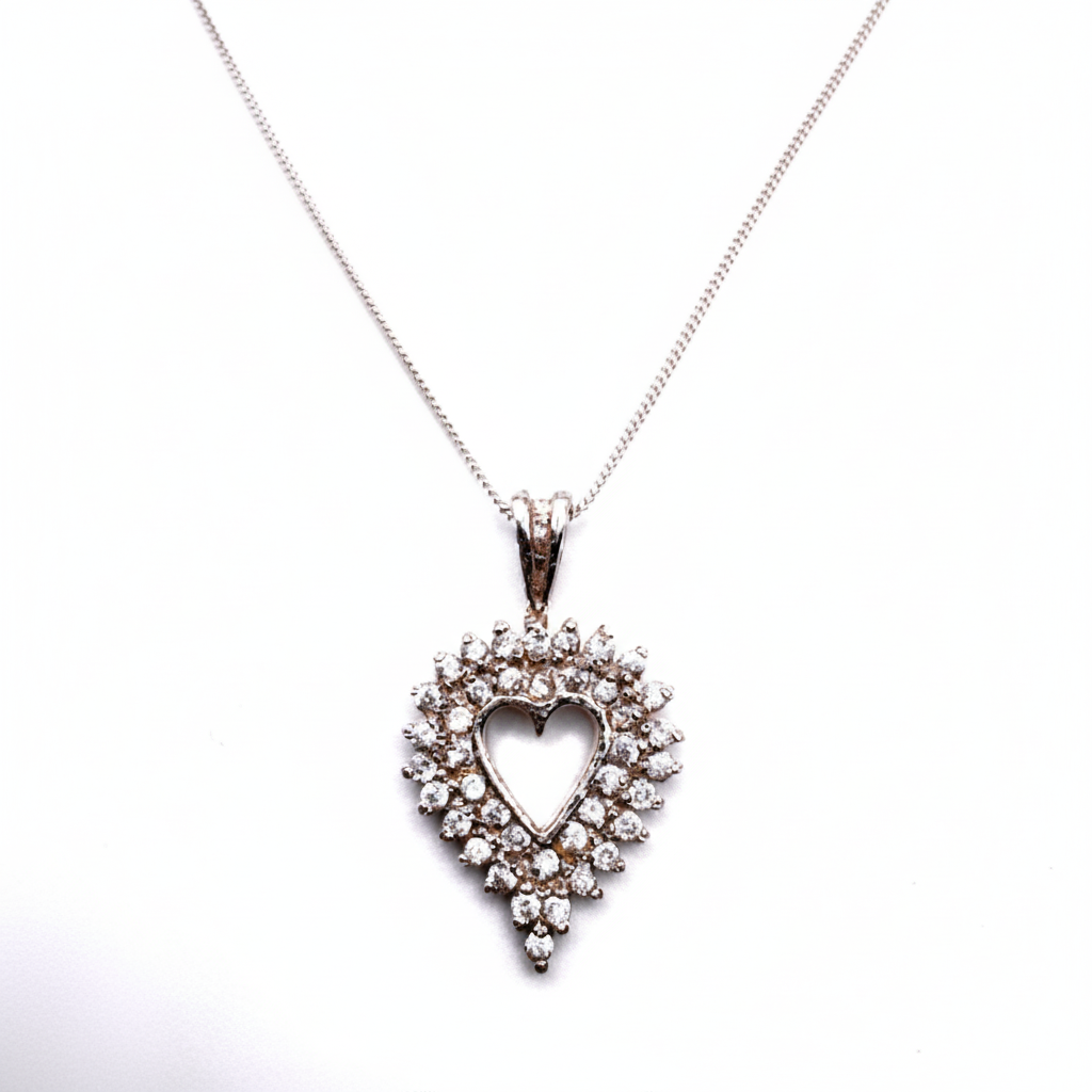 Heart-shaped diamond pendant on a white background