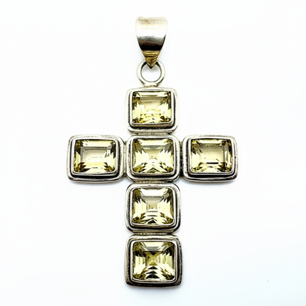 Silver pendant with square-cut yellow gemstones on a white background