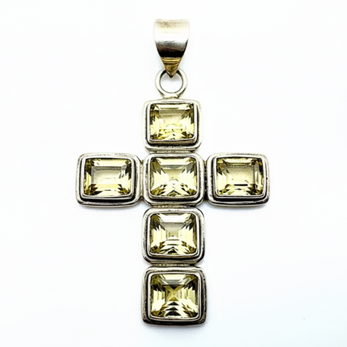 Silver pendant with square-cut yellow gemstones on a white background