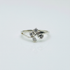 Silver ring with three diamond-like stones on a light gray background