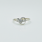Silver ring with a heart-shaped diamond on a light gray background