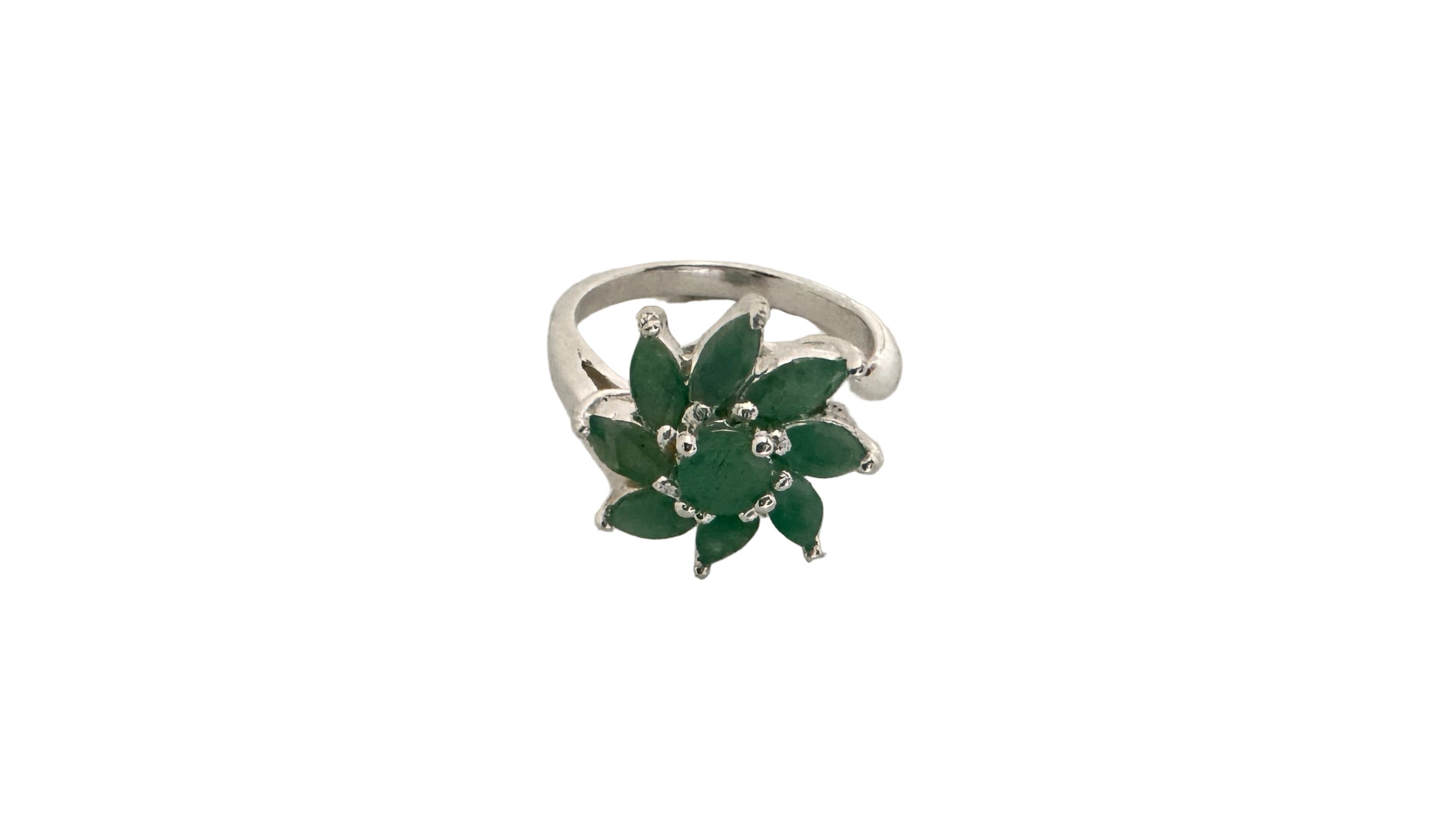 Silver ring with green gemstones on a light gray background