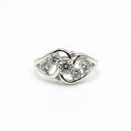 Silver ring with clear gemstones on a white background