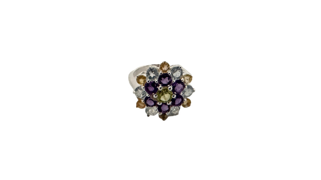 Jewelry ring with multicolored gemstones on a white background