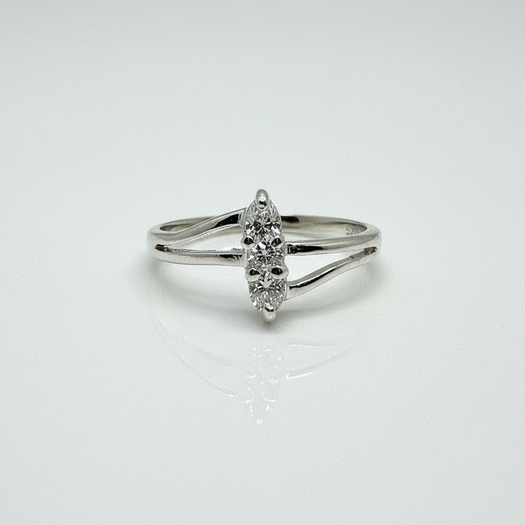 Silver ring with a diamond on a light gray background