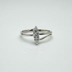 Silver ring with a diamond on a light gray background