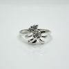 Silver ring with a starfish design on a white background