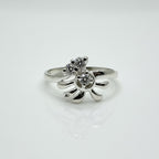 Silver ring with a starfish design on a white background