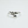Silver ring with a diamond on a white background