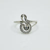 Silver ring with diamond accents on a light gray background