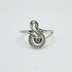 Silver ring with diamond accents on a light gray background
