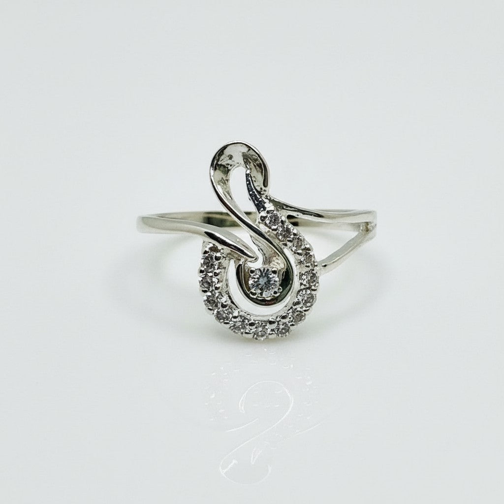 Silver ring with diamond accents on a light gray background