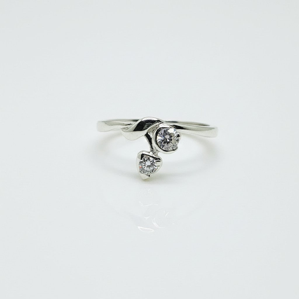 Silver ring with two heart-shaped gemstones on a white background