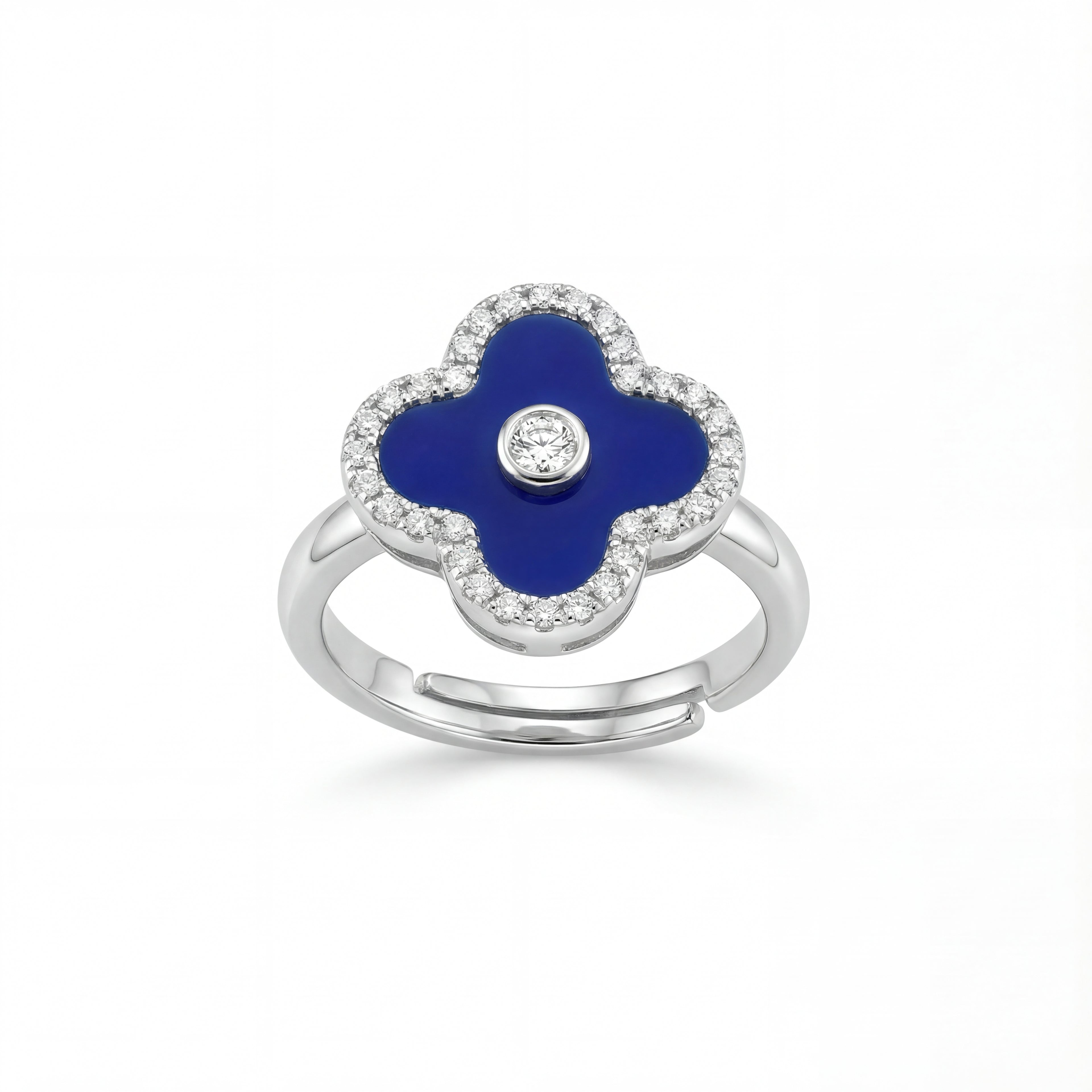 Silver ring with a blue clover-shaped stone and clear stones on a white background