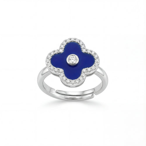 Silver ring with a blue clover-shaped stone and clear stones on a white background