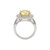 Ring with a yellow gemstone and diamond accents on a white background