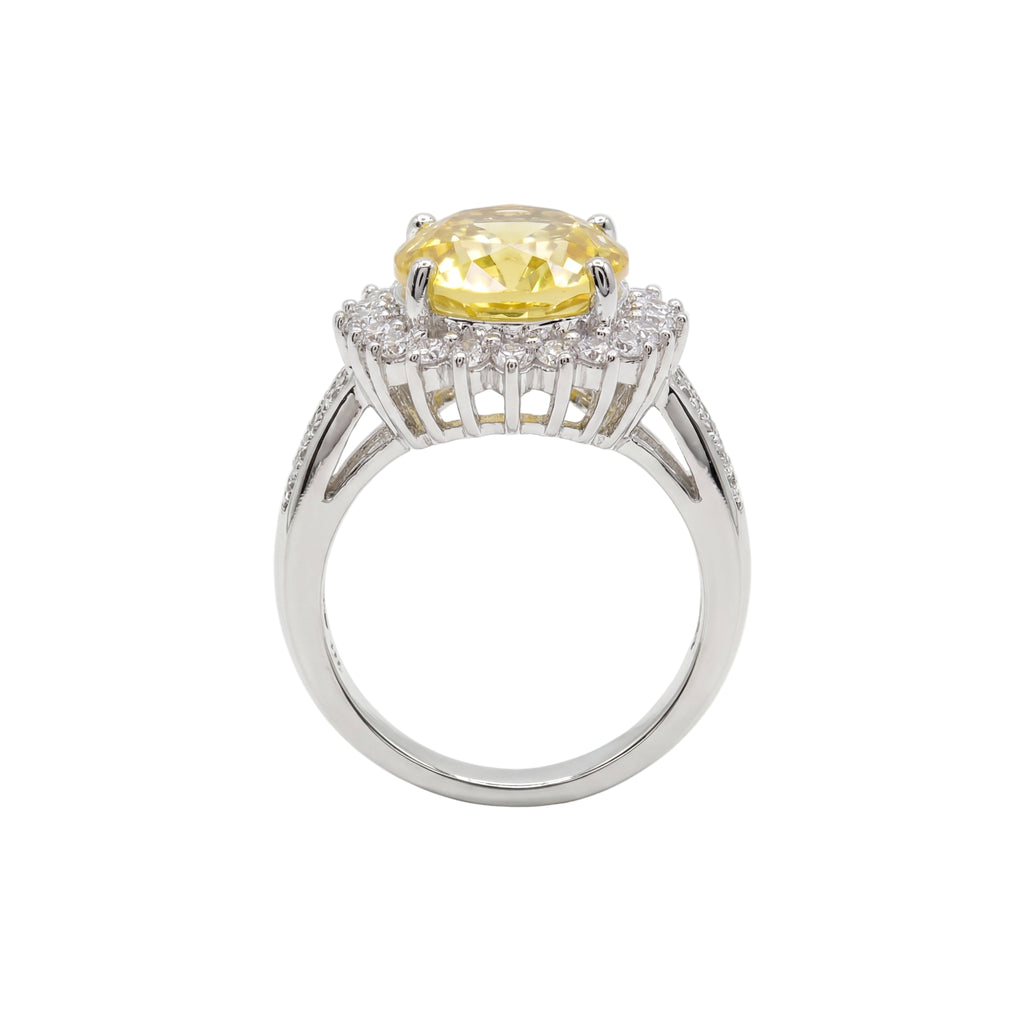 Ring with a yellow gemstone and diamond accents on a white background