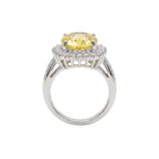 Ring with a yellow gemstone and diamond accents on a white background