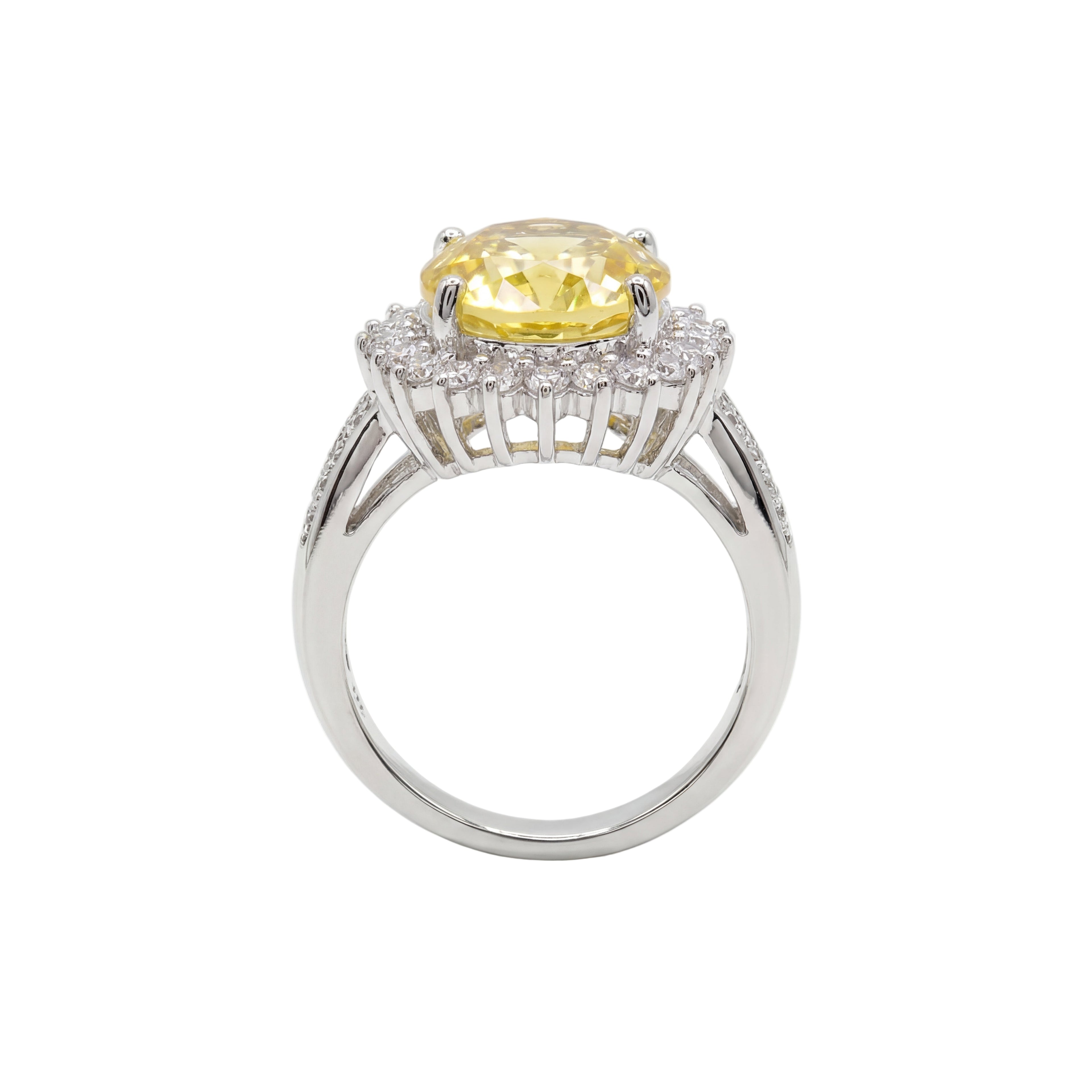 Ring with a yellow gemstone and diamond accents on a white background