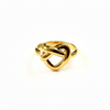 Gold ring with a knot design on a white background