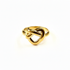 Gold ring with a knot design on a white background