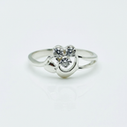 Silver ring with a heart-shaped diamond on a white background